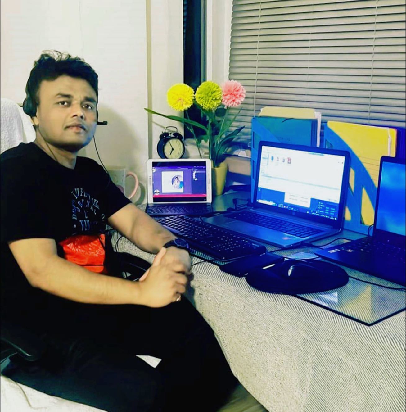 Habibur Rahman working at his multi-monitor digital workspace, focused on AI automation and graphic design for Design Sparks Ads, Germany.